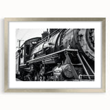 Textured abstract art print featuring assorted vehicles in muted earth tones on a framed silver mat.