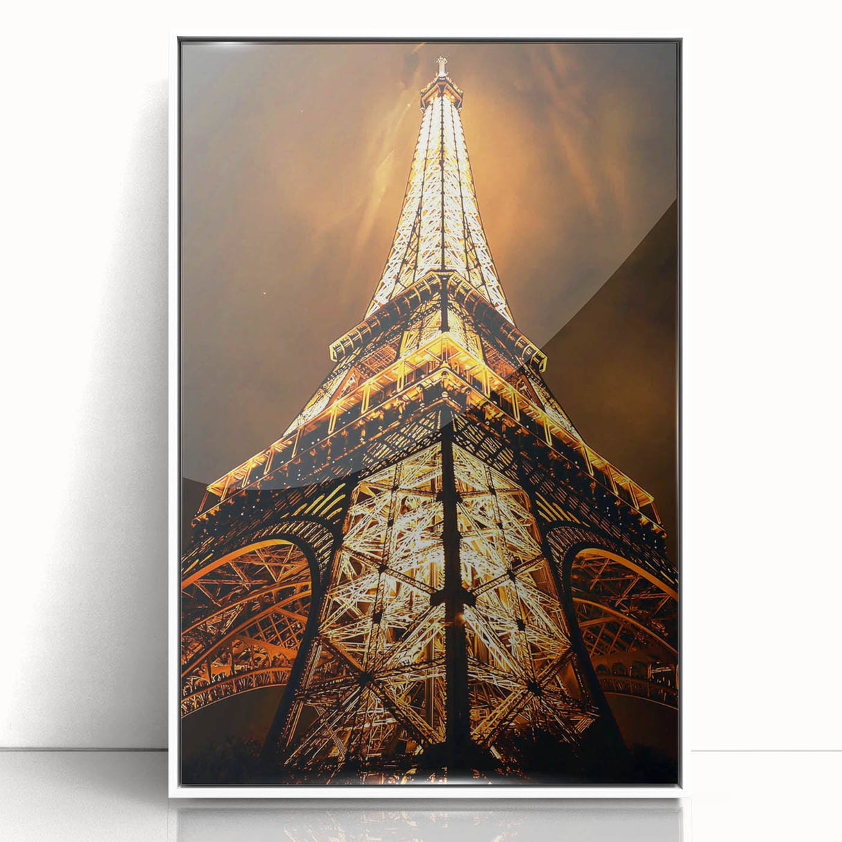 Art deco poster featuring geometric shapes in black and gold on a white acrylic frame.