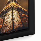 Close-up of a large framed canvas featuring black textured architecture with colorful accents, ideal for living room decor.