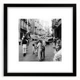 Abstract art print featuring vibrant splashes of color on a textured surface, framed in black, ideal for living room decor.