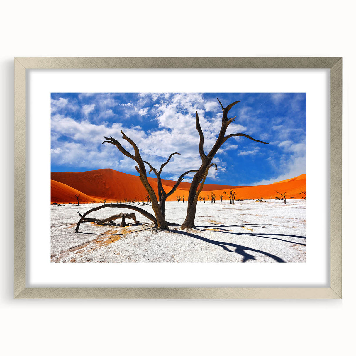 Abstract art print of African scenery in muted earth tones on a silver-framed mat, suitable for dining room decor.