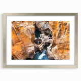 Textured abstract art print depicting a South African landscape in muted earth tones, framed in silver.