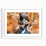 Abstract art print of an African landscape in muted earth tones on a white framed canvas, ideal for dining room decor.