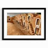 Abstract art print of a vibrant, colorful African scenery on a large textured canvas, framed in black.