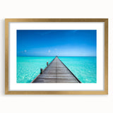 Extra large abstract art print depicting a serene Maldivian landscape in blue and green tones, framed in gold.