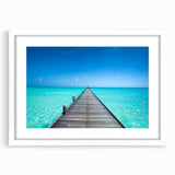 Abstract art print of Maldives scenery in muted blue and green tones, framed with a white mat.