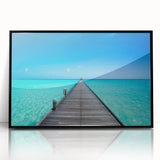 Large abstract wall art featuring a serene Maldivian landscape in muted blue and green tones, framed in black acrylic.