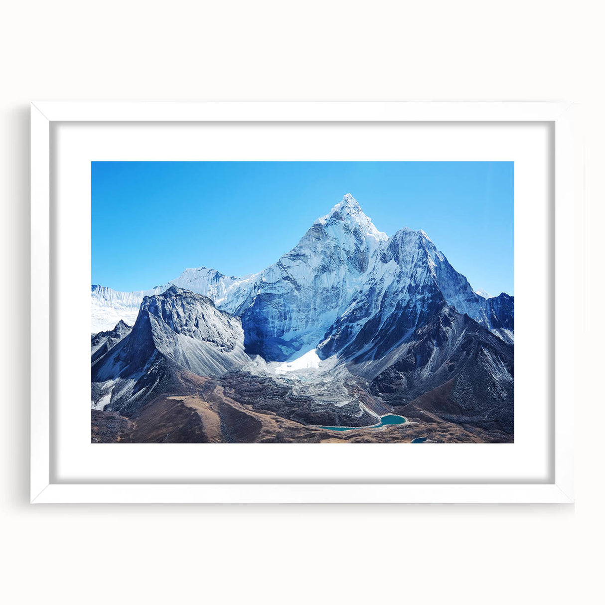 Abstract art print of Mount Everest in muted blue and white tones, framed with a white mat.