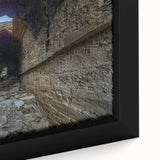 Framed canvas featuring a textured, colorful abstract design with black elements.