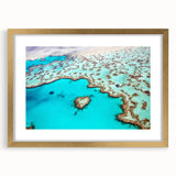 Textured abstract art print of the Great Barrier Reef in blue and green tones on a framed canvas, suited for bedroom art.