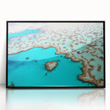 Large abstract wall art of the Great Barrier Reef in vibrant blue tones, framed in black acrylic.
