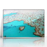 Acrylic print of the Great Barrier Reef in vibrant blues and greens, framed in white, suitable for modern nursery wall art.