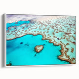 Framed canvas wall art depicting the Great Barrier Reef in vibrant blue and green tones, ideal for bedroom ambiance.
