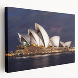 Side view of a large stretched canvas featuring a detailed Sydney skyline in muted blue and gray tones.
