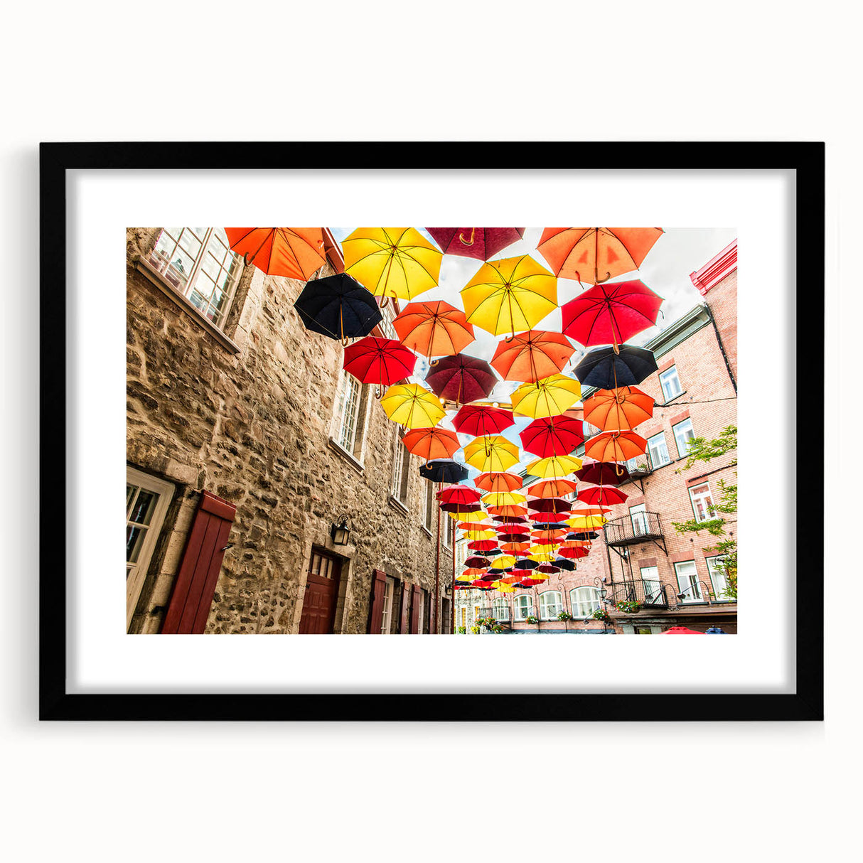 Colorful abstract art print of a textured Quebec scenery in a large black frame, ideal for living room decor.