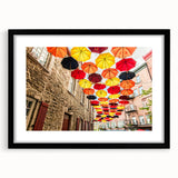 Colorful abstract art print of a textured Quebec scenery in a large black frame, ideal for living room decor.