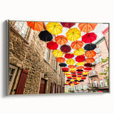 Framed canvas featuring a vintage-style landscape painting of Quebec, with colorful art on a black background.