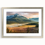 Textured art print depicting an abstract landscape in muted earth tones, framed in silver, suitable for bedroom decor.