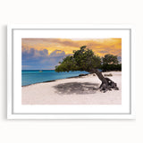 Textured abstract art print of a Caribbean scenery in muted blue and green tones, framed with a white mat.
