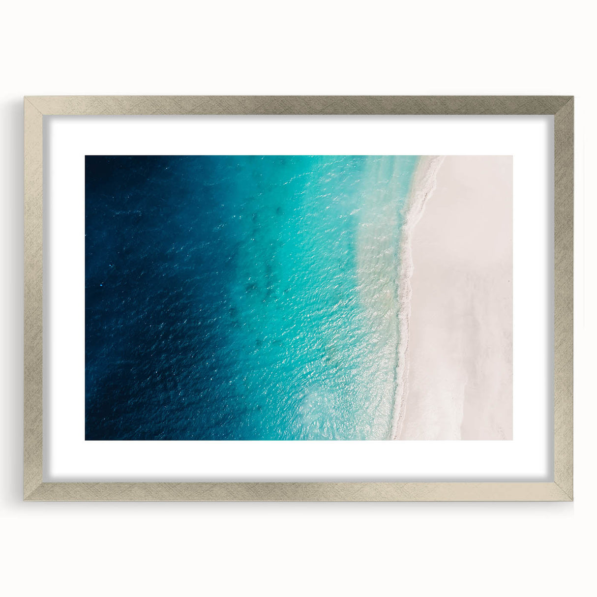 Extra large abstract art print of Caribbean scenery in silver frame, featuring textured blue and green hues.