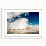 Textured art print of abstract Caribbean scenery in muted blue and green tones, framed in white, suitable for bedroom decor.