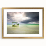 Abstract art print of a Caribbean seascape in vibrant blues and greens, framed in gold.