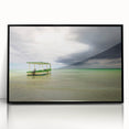 Large abstract wall art depicting a Caribbean scenery in muted blue and green tones, framed in black acrylic.