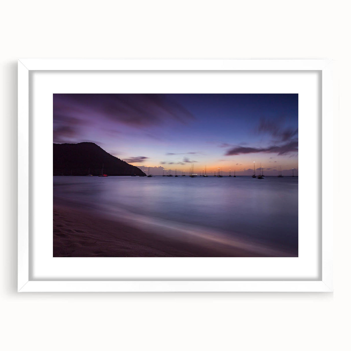 Textured art print of abstract Caribbean scenery in muted blue and green tones on a white-framed mat, ideal for bedroom art.