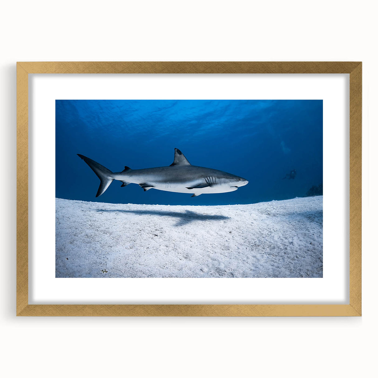 Abstract art print of a Caribbean scene in a gold frame, featuring deep blue and turquoise tones.