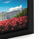 Black wall art featuring a textured depiction of a European landscape in vibrant colors on a framed canvas.