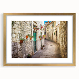 Abstract art print of a European Croatian scenery in muted earth tones, framed in gold, suitable for dining room decor.