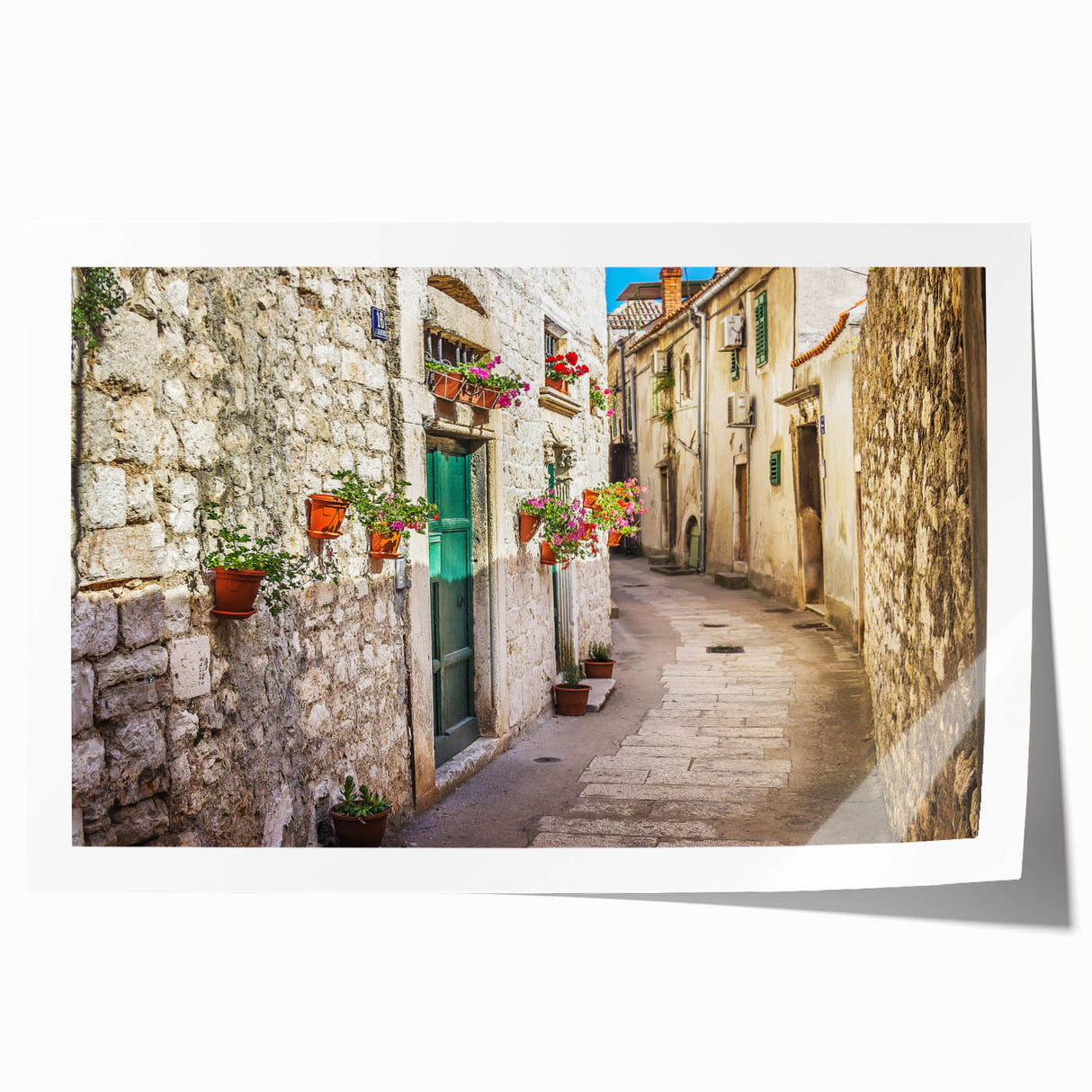 Rolled print of a Croatian landscape featuring vibrant greens and blues, ideal for dining room wall art.