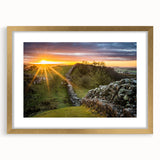 Abstract art print of Cumbria's landscape in muted earth tones on a framed gold mat, suitable for dining room decor.