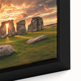 Close-up of black wall art featuring a textured depiction of Stonehenge in muted earth tones on a framed canvas.