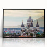 Large abstract wall art depicting a European scenery, in muted gray and blue tones on a black framed acrylic.