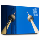 Large abstract art print of Berlin skyline in muted gray and blue tones on acrylic glass.