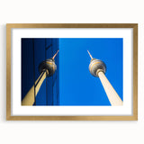Abstract art print of Berlin skyline in muted gray and blue tones on a framed canvas, suitable for dining room decor.
