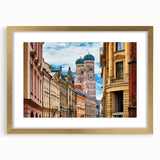 Abstract art print of Munich skyline in muted gray and blue tones on a gold-framed canvas.