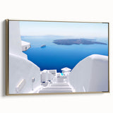 Framed canvas of Santorini landscape in muted blue and white, ideal for bedroom wall art.