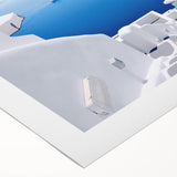 Art deco poster of Santorini landscape on rolled canvas, featuring white buildings and blue roofs.