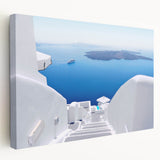 Large art print of Santorini, Greece, featuring white buildings and blue domes on stretched canvas.