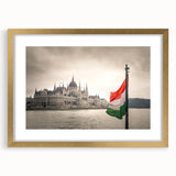 Abstract art print depicting a European scenery in muted earth tones, framed in gold, suitable for dining room decor.