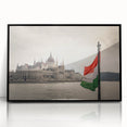 Large abstract wall art depicting a European scenery in muted earth tones, framed in black acrylic.