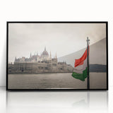 Large abstract wall art depicting a European scenery in muted earth tones, framed in black acrylic.