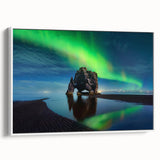 Vintage poster art of an Icelandic landscape on a framed canvas, featuring a black and colorful palette.