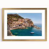 Abstract art print of Cinque Terre with vibrant coastal colors on a framed gold mat, ideal for dining room decor.
