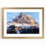 Abstract art print of the Dolomites in Italy, featuring muted earth tones on a framed canvas, suitable for dining room decor.