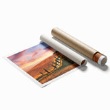 Rolled print of Tuscan landscape with lush green fields and distant hills, ideal for classy bathroom wall art.