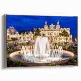 Landscape art painting of Monaco featuring colorful buildings and sea, displayed on a silver-framed canvas.
