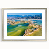 Textured abstract art print of Oaxaca scenery in muted earth tones, framed in silver, ideal for bedroom decor.